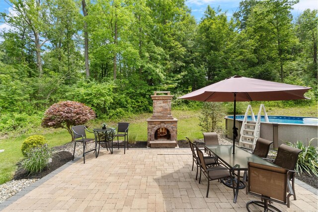 1 Hidden Hills Ct, Warwick, NY 10990 - view of patio featuring an outdoor stone fireplace, outdoor dining area, and an outdoor pool
