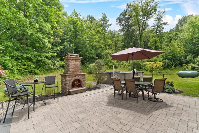 1 Hidden Hills Ct, Warwick, NY 10990 - view of patio / terrace featuring outdoor dining area, an outdoor stone fireplace, and a wooded view