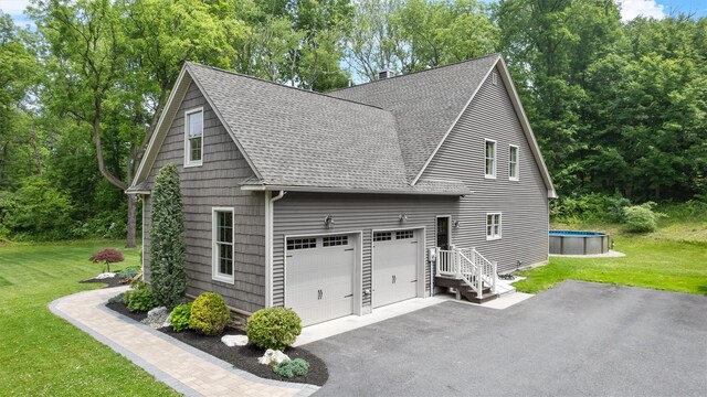 1 Hidden Hills Ct, Warwick, NY 10990 - view of side of home featuring a shingled roof, a garage, a lawn, and an outdoor pool