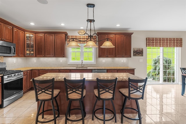 14 Eagles Watch, Warwick, NY 10990 - kitchen featuring stainless steel appliances, a breakfast bar area, backsplash, glass insert cabinets, and recessed lighting