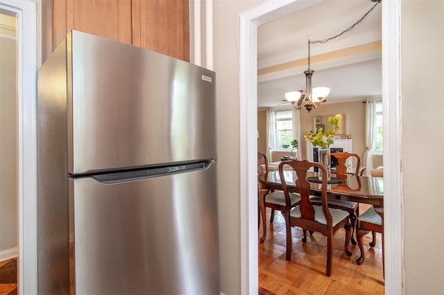 1360 Midland Ave Unit 1B, Bronxville, NY 10708 - kitchen with freestanding refrigerator, ornamental molding, a chandelier, and decorative light fixtures