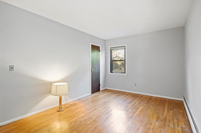 175 Laurel Ln, Laurel Hollow, NY 11791 - spare room with a baseboard radiator and wood finished floors