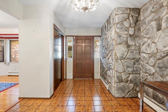 175 Laurel Ln, Laurel Hollow, NY 11791 - foyer featuring a chandelier and a baseboard heating unit