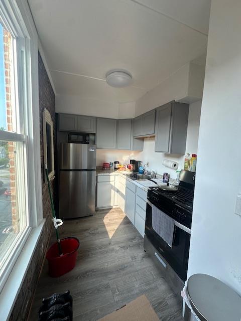 457 Main St Apt 5, Beacon, NY 12508 - kitchen featuring appliances with stainless steel finishes, gray cabinetry, plenty of natural light, and wood finished floors