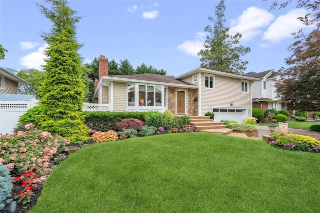 86 Phipps Ln, Plainview, NY 11803 - tri-level home with a chimney, a garage, a front yard, driveway, and stone siding