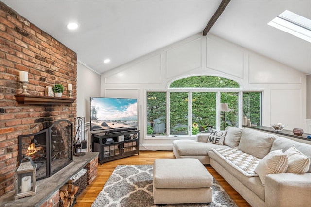 86 Phipps Ln, Plainview, NY 11803 - living area featuring a decorative wall, wood finished floors, a brick fireplace, and a skylight