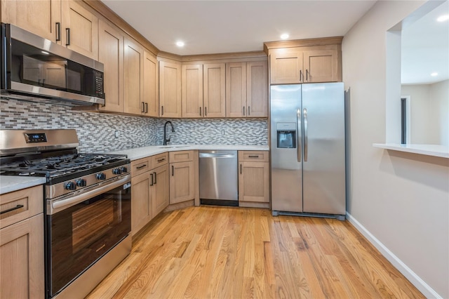 255 Country Club Ln, Pomona, NY 10970 - kitchen with appliances with stainless steel finishes, light wood-type flooring, light countertops, decorative backsplash, and recessed lighting