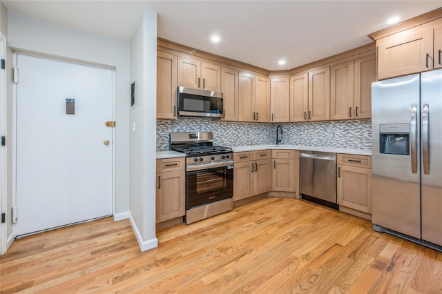 255 Country Club Ln, Pomona, NY 10970 - kitchen with appliances with stainless steel finishes, light countertops, light wood-style flooring, decorative backsplash, and recessed lighting