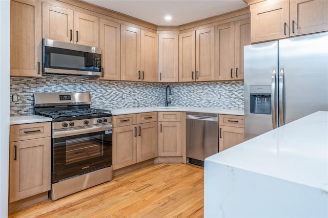 255 Country Club Ln, Pomona, NY 10970 - kitchen featuring appliances with stainless steel finishes, light countertops, light wood finished floors, light brown cabinets, and tasteful backsplash
