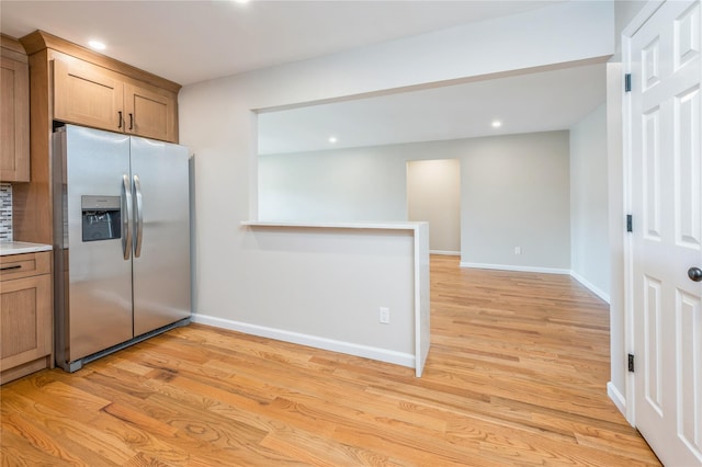 255 Country Club Ln, Pomona, NY 10970 - kitchen featuring stainless steel fridge with ice dispenser, light wood finished floors, light countertops, recessed lighting, and brown cabinets