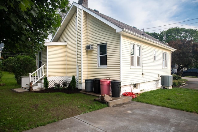 19 Harper Ave, Montrose, NY 10548 - view of side of home featuring a chimney, a lawn, and a wall mounted air conditioner