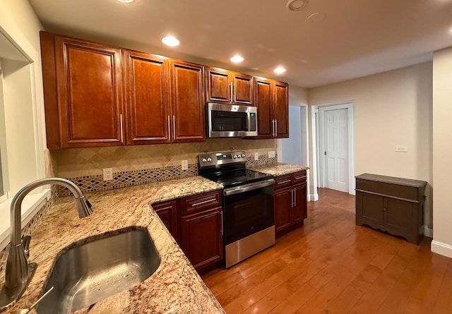 19 Harper Ave, Montrose, NY 10548 - kitchen with stainless steel appliances, recessed lighting, tasteful backsplash, light stone counters, and light wood-style floors