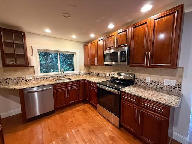 19 Harper Ave, Montrose, NY 10548 - kitchen featuring stainless steel appliances, light wood finished floors, light stone countertops, tasteful backsplash, and recessed lighting