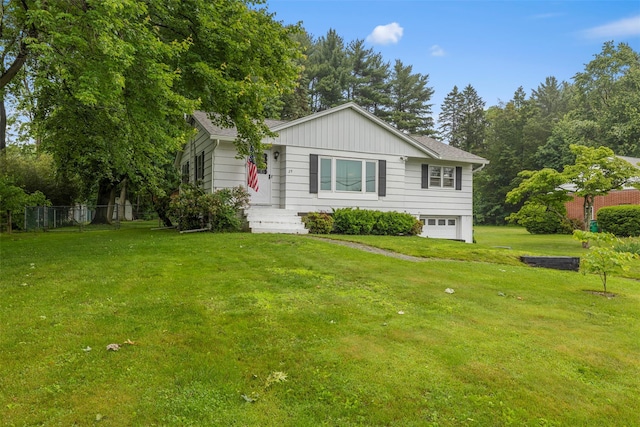 29 Chestnut St, Poughkeepsie, NY 12601 - view of front of house with an attached garage, a front yard, and board and batten siding