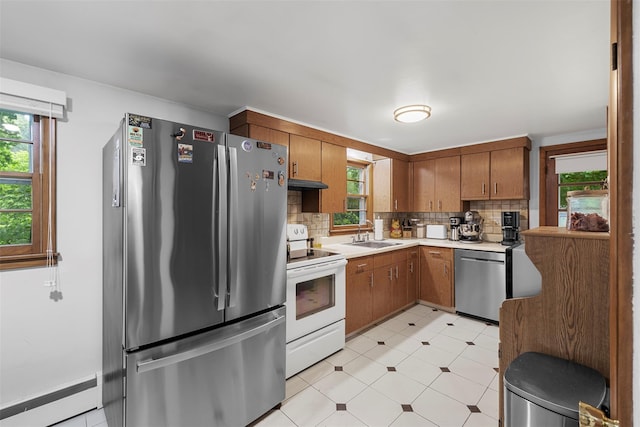 29 Chestnut St, Poughkeepsie, NY 12601 - kitchen featuring appliances with stainless steel finishes, baseboard heating, light flooring, light countertops, and under cabinet range hood