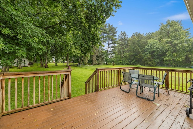 29 Chestnut St, Poughkeepsie, NY 12601 - wooden deck featuring outdoor dining space, a lawn, a storage shed, and view of scattered trees