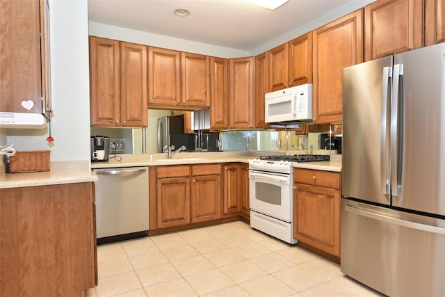 30 N De Baun Ave N Unit 208, Suffern, NY 10901 - kitchen featuring appliances with stainless steel finishes, light countertops, brown cabinets, and recessed lighting