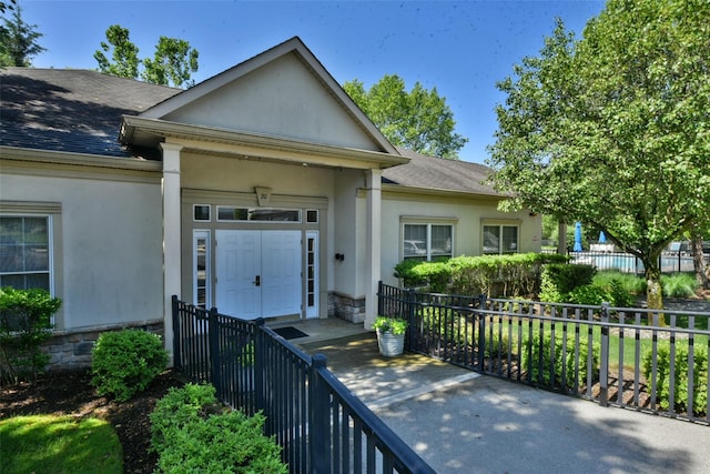30 N De Baun Ave N Unit 208, Suffern, NY 10901 - property entrance with stucco siding, roof with shingles, and stone siding