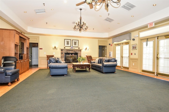 30 N De Baun Ave N Unit 208, Suffern, NY 10901 - living area with a chandelier, a decorative wall, a tray ceiling, a glass covered fireplace, and wainscoting