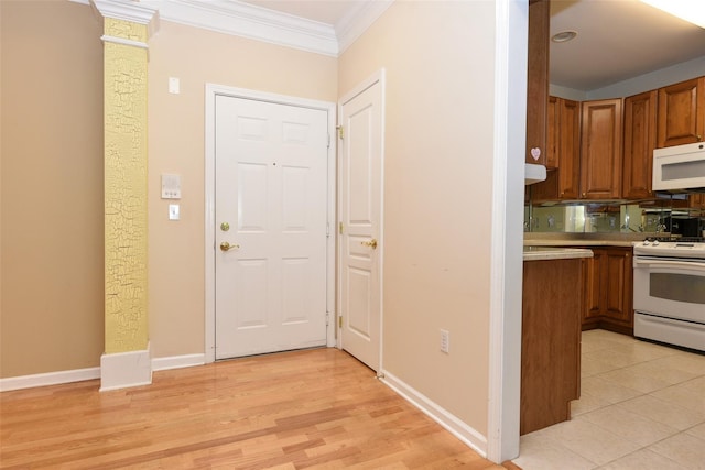 30 N De Baun Ave N Unit 208, Suffern, NY 10901 - kitchen featuring white appliances, crown molding, light countertops, brown cabinets, and light wood-style floors