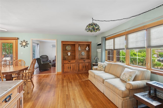 6 Grey Rock Ct, Bethpage, NY 11714 - living room featuring light wood-style flooring, healthy amount of natural light, and an AC wall unit