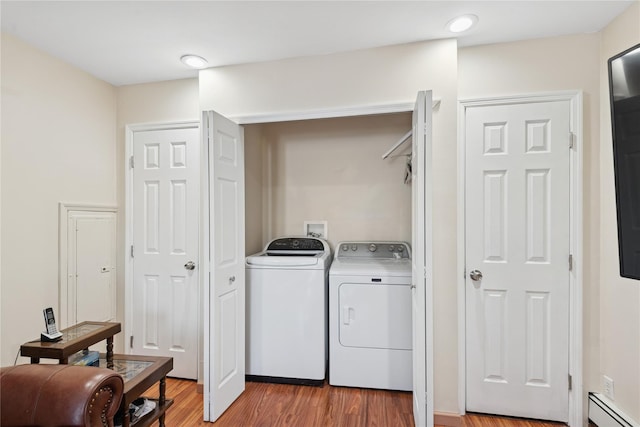 6 Grey Rock Ct, Bethpage, NY 11714 - washroom featuring a baseboard heating unit, independent washer and dryer, and light wood-type flooring