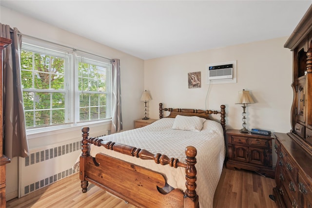 6 Grey Rock Ct, Bethpage, NY 11714 - bedroom featuring radiator, an AC wall unit, and wood finished floors