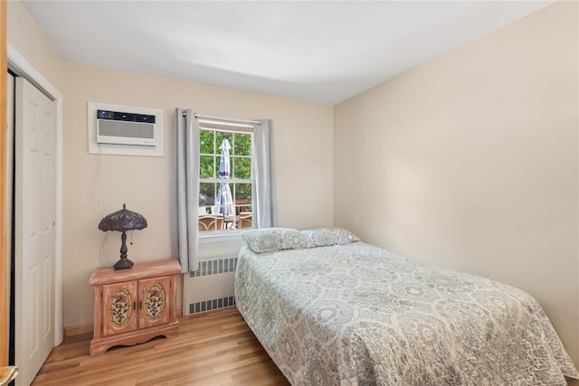 6 Grey Rock Ct, Bethpage, NY 11714 - bedroom featuring radiator, light wood finished floors, a wall mounted AC, and a closet