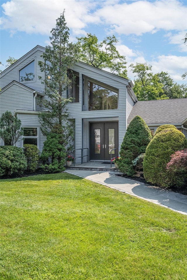 64 Highland Ave, Roslyn, NY 11576 - view of front of home featuring french doors and a front lawn