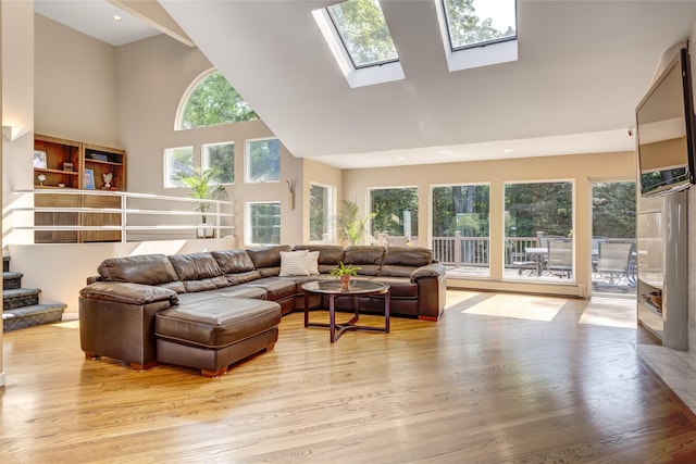 64 Highland Ave, Roslyn, NY 11576 - living room featuring high vaulted ceiling, healthy amount of natural light, light wood-style floors, recessed lighting, and a skylight