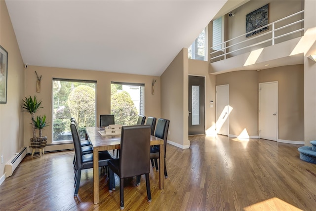 64 Highland Ave, Roslyn, NY 11576 - dining space featuring healthy amount of natural light, wood finished floors, high vaulted ceiling, and a baseboard heating unit