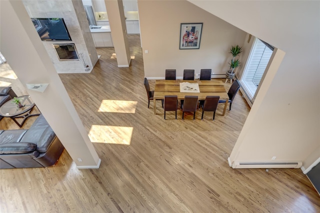 64 Highland Ave, Roslyn, NY 11576 - dining space with wood finished floors and a baseboard heating unit