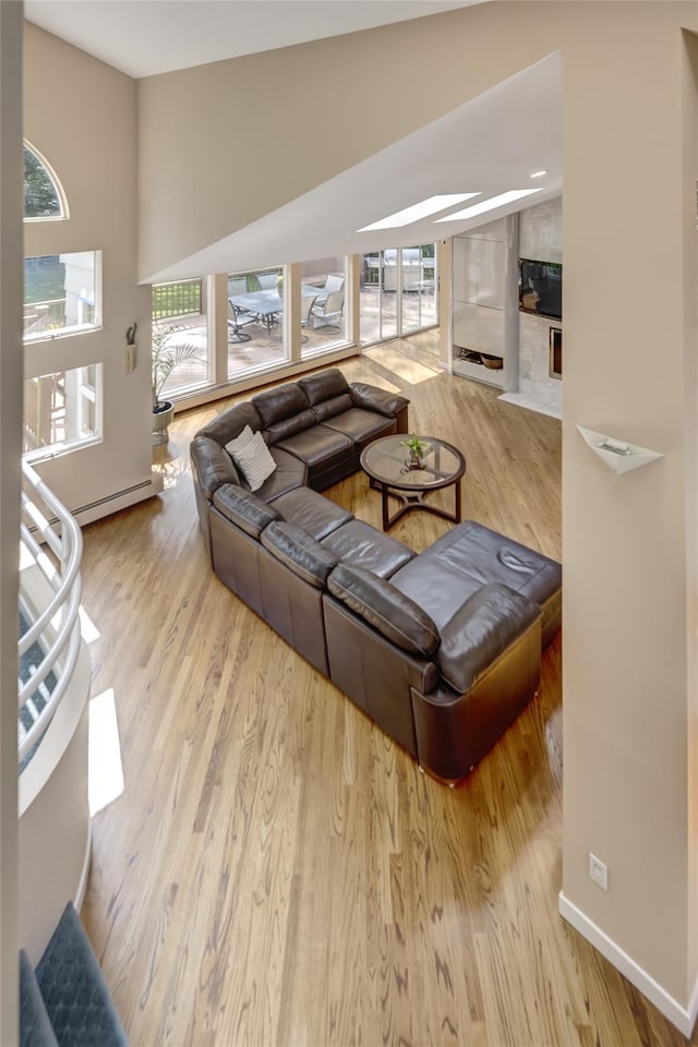 64 Highland Ave, Roslyn, NY 11576 - living room with wood finished floors and a baseboard heating unit