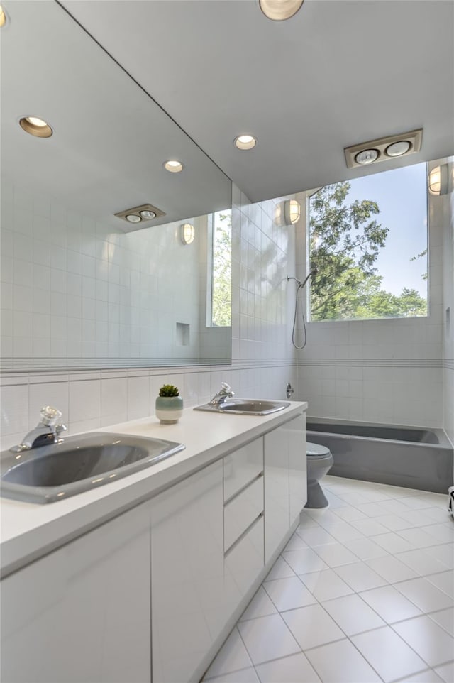 64 Highland Ave, Roslyn, NY 11576 - bathroom featuring tile walls, double vanity, tile patterned floors, recessed lighting, and shower / washtub combination