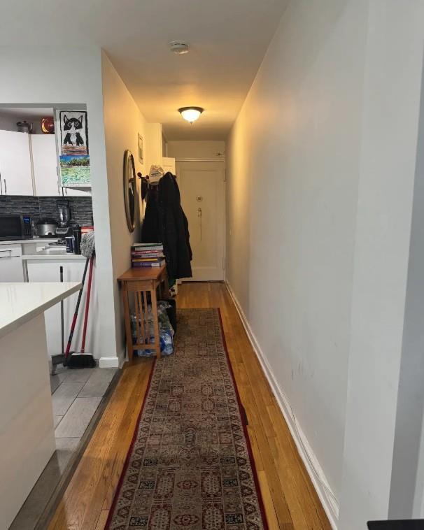 65-39 108th St Unit E6, Forest Hills, NY 11375 - corridor featuring light wood-style floors and baseboards