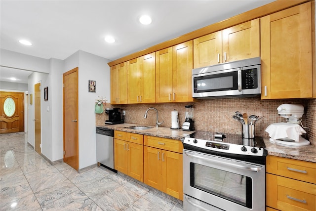 2616 Brown St, Brooklyn, NY 11235 - kitchen featuring appliances with stainless steel finishes, light marble finish floors, light stone countertops, backsplash, and recessed lighting