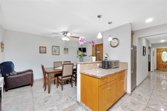 2616 Brown St, Brooklyn, NY 11235 - kitchen with freestanding refrigerator, light marble finish flooring, ceiling fan, backsplash, and hanging light fixtures