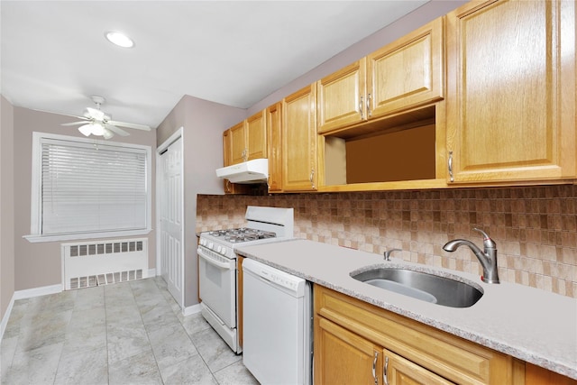 2616 Brown St, Brooklyn, NY 11235 - kitchen with radiator, white appliances, under cabinet range hood, ceiling fan, and decorative backsplash