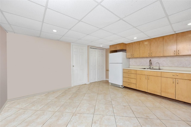 2616 Brown St, Brooklyn, NY 11235 - kitchen with freestanding refrigerator, light countertops, a paneled ceiling, tasteful backsplash, and recessed lighting