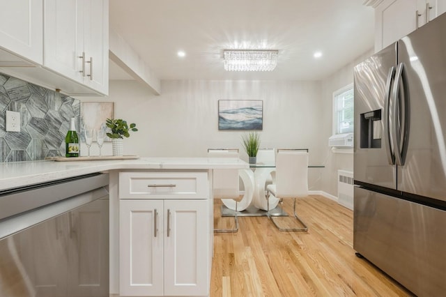 1086 Lehman Rd, West Hempstead, NY 11552 - kitchen with stainless steel appliances, light wood finished floors, light countertops, white cabinetry, and recessed lighting