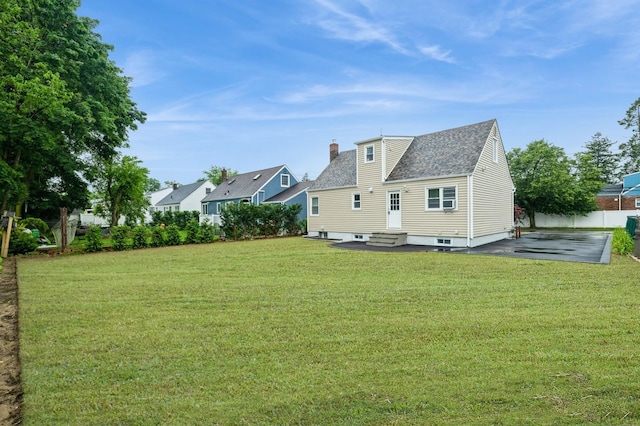 1086 Lehman Rd, West Hempstead, NY 11552 - rear view of house with a chimney, entry steps, a patio, and a shingled roof