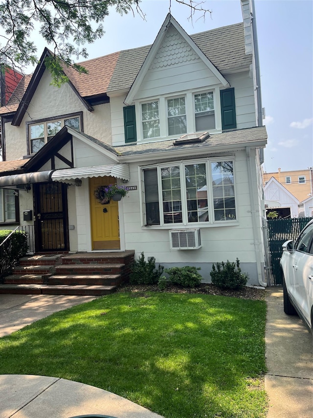 88-43 75th Ave, Glendale, NY 11385 - view of front of property featuring roof with shingles, an AC wall unit, and a chimney