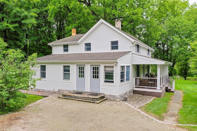 591 Hillside Lake Rd, Wappingers Falls, NY 12590 - view of front facade featuring a chimney, a porch, view of wooded area, and a shingled roof
