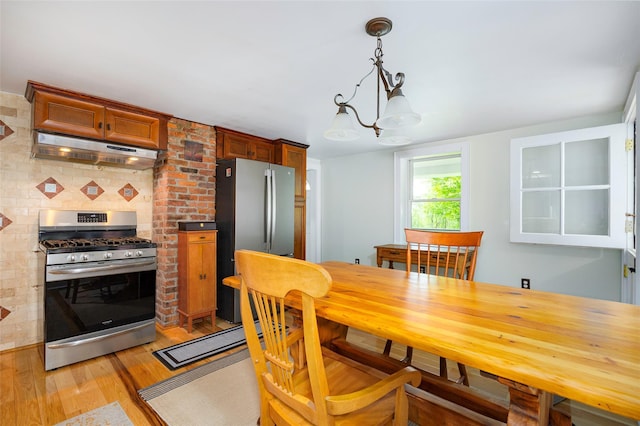 591 Hillside Lake Rd, Wappingers Falls, NY 12590 - dining space featuring light wood finished floors and a chandelier