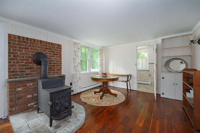591 Hillside Lake Rd, Wappingers Falls, NY 12590 - living area featuring a wood stove, a baseboard radiator, crown molding, and wood-type flooring