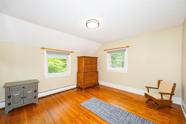591 Hillside Lake Rd, Wappingers Falls, NY 12590 - living area with a baseboard heating unit, wood finished floors, and lofted ceiling