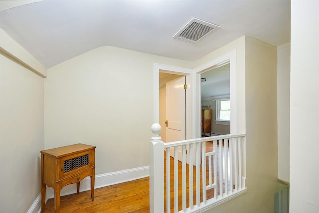 591 Hillside Lake Rd, Wappingers Falls, NY 12590 - corridor featuring wood finished floors, an upstairs landing, and vaulted ceiling
