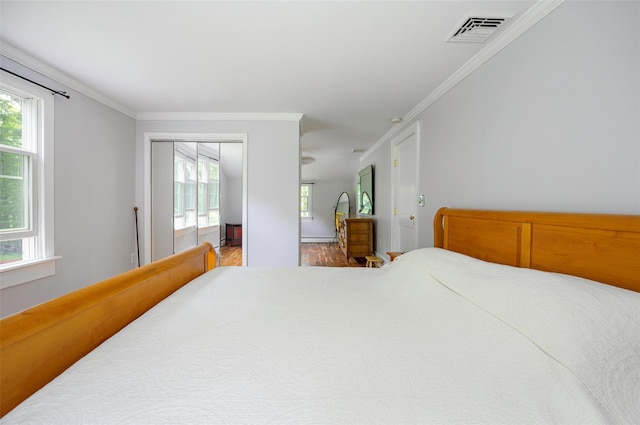 591 Hillside Lake Rd, Wappingers Falls, NY 12590 - bedroom featuring ornamental molding, wood finished floors, and baseboard heating