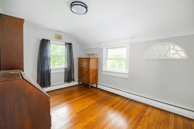 591 Hillside Lake Rd, Wappingers Falls, NY 12590 - unfurnished bedroom featuring baseboard heating, vaulted ceiling, and light wood-type flooring
