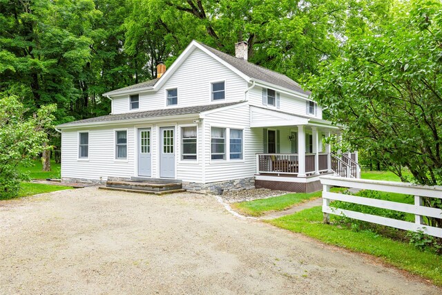 591 Hillside Lake Rd, Wappingers Falls, NY 12590 - view of front of house featuring covered porch, a chimney, roof with shingles, dirt driveway, and view of scattered trees